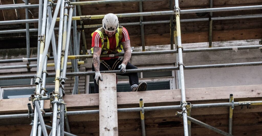 superior scaffolding auckland workers passing down timber